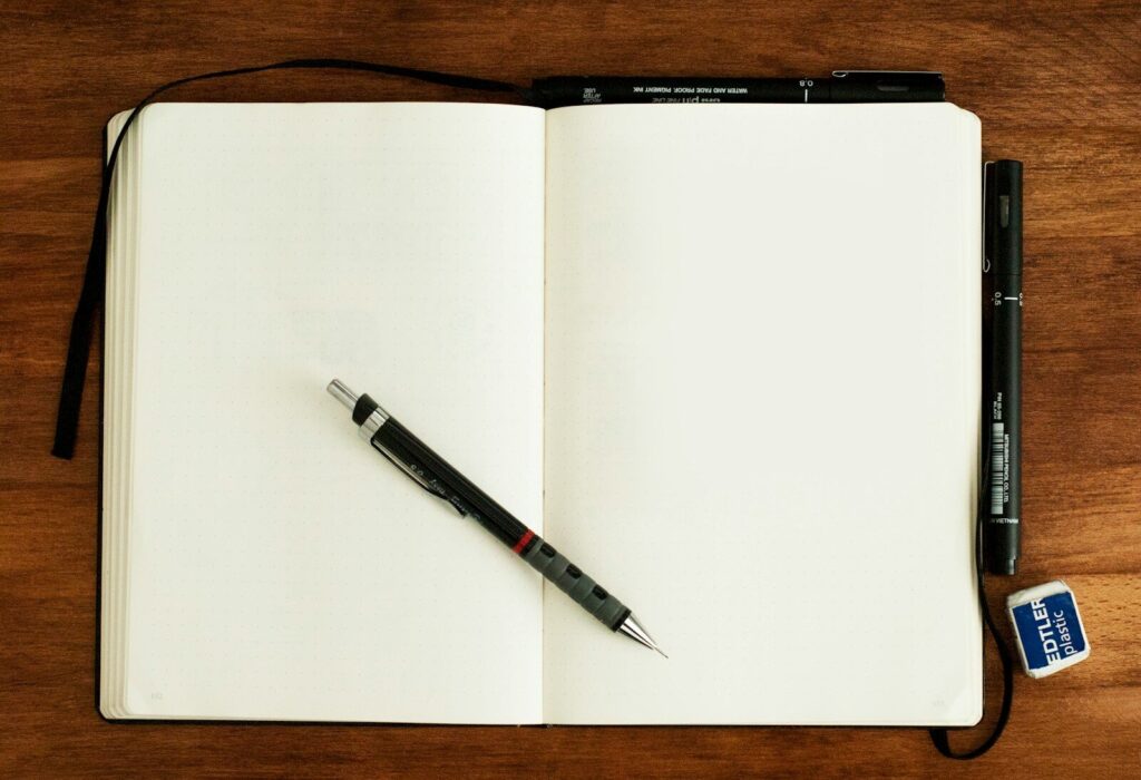25 Refreshing Things to Do Outside by Yourself 6 black and silver retractable pen on blank book