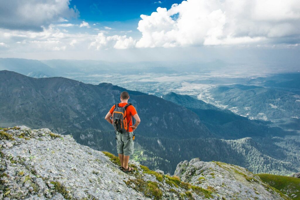 25 Refreshing Things to Do Outside by Yourself 4 man standing on peak front of mountain at daytime
