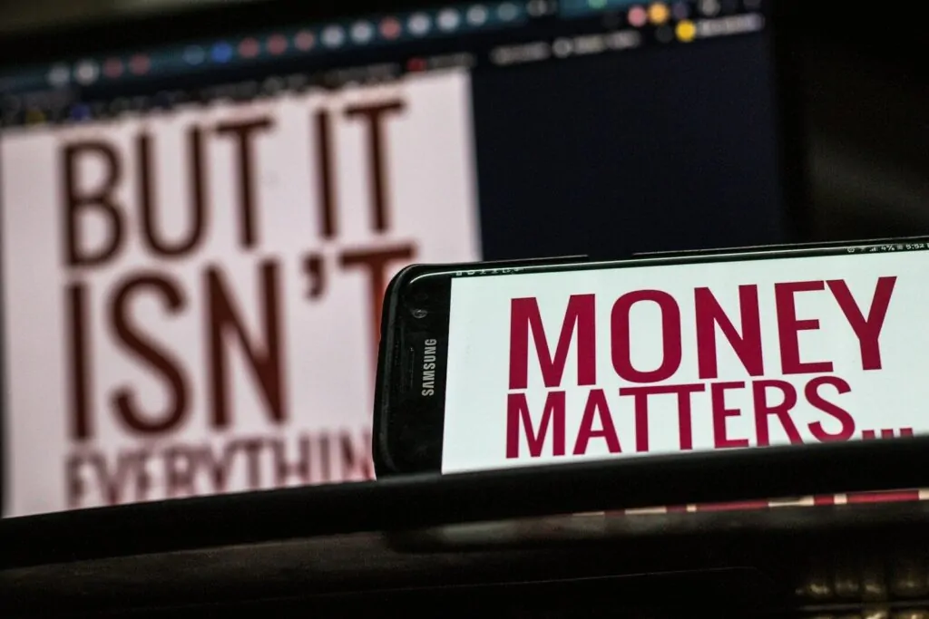 a cell phone sitting on top of a table 10 Money Traps Real Millionaires Avoid at All Costs (Most People Fail Here)