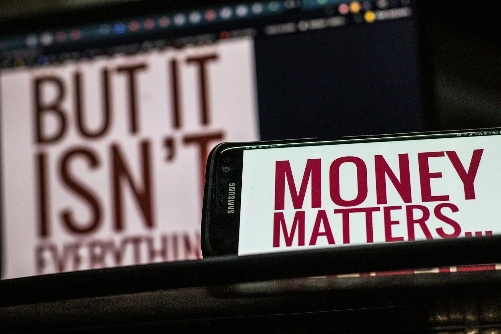 a cell phone sitting on top of a table 10 Money Traps Real Millionaires Avoid at All Costs (Most People Fail Here)