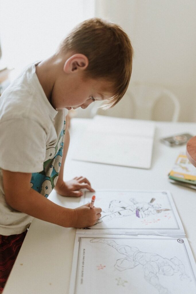 13 Cognitive Development Activities to Boost Brain Growth in Kids 8 a young boy drawing on a white board