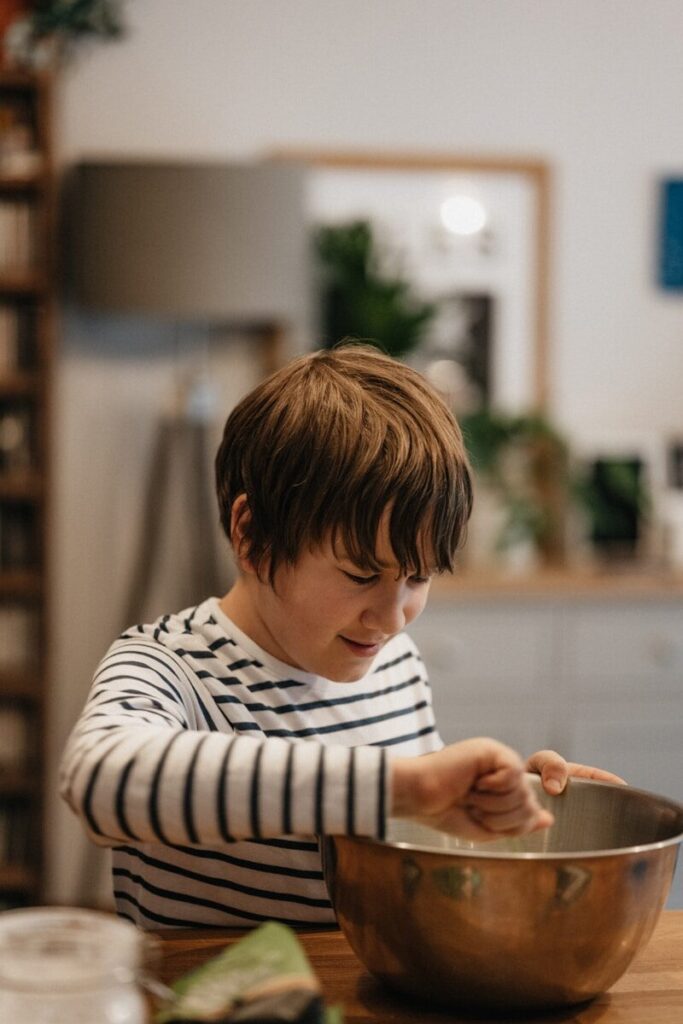 13 Cognitive Development Activities to Boost Brain Growth in Kids 11 boy in white and black striped long sleeve shirt holding brown wooden cup