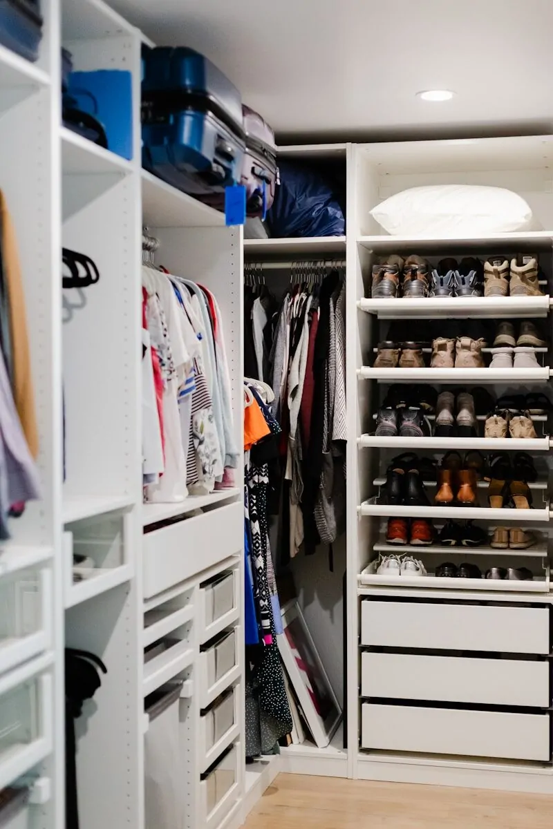 a walk in closet filled with lots of shoes