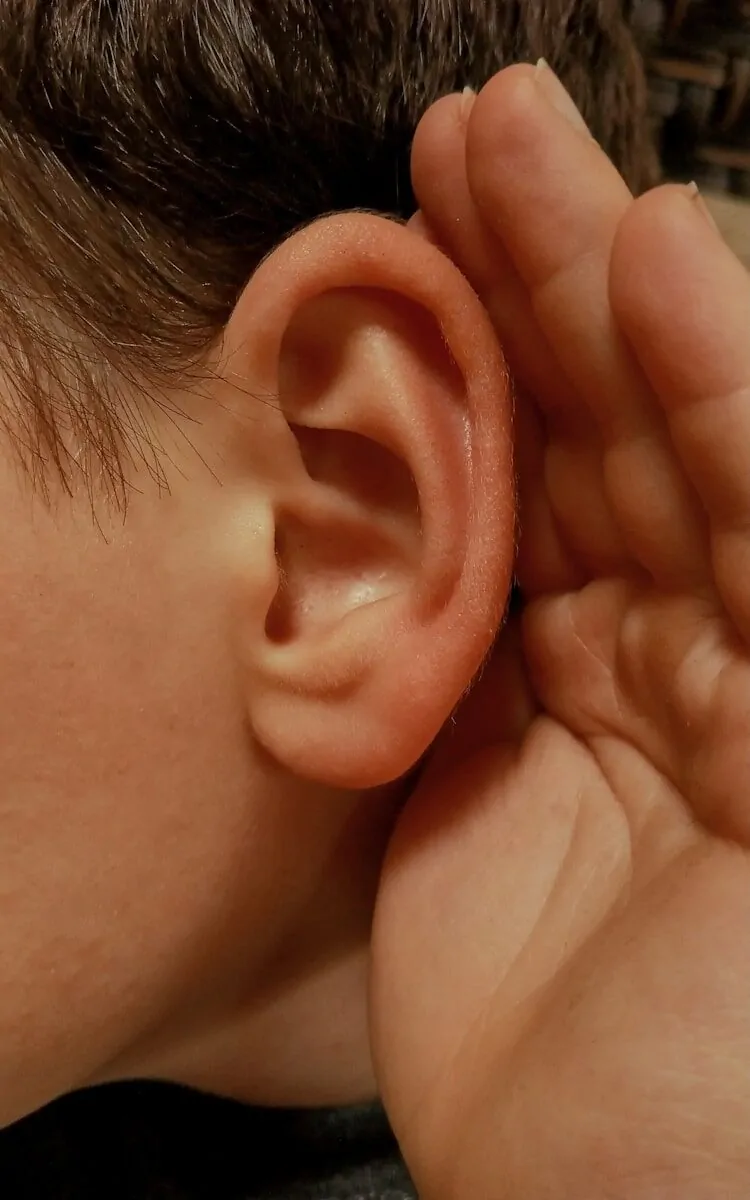 8 Powerful Anger Management Skills That Will Instantly Calm Your Mind 5 A person cupping their ear to listen closely