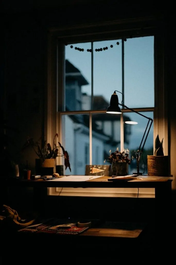 60 Meaningful Things to Do With Your Parents for Every Season and Situation 21 a window with a lamp and a table with objects on it