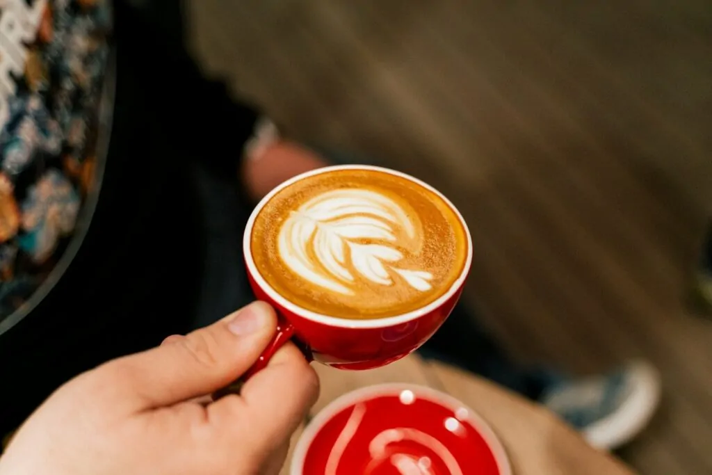 How to Become Someone’s Favorite Person Naturally 1 a person holding a cup of coffee in their hand
