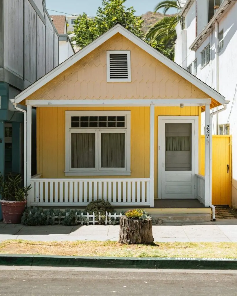 60 Meaningful Things to Do With Your Parents for Every Season and Situation 9 a yellow house with a white fence