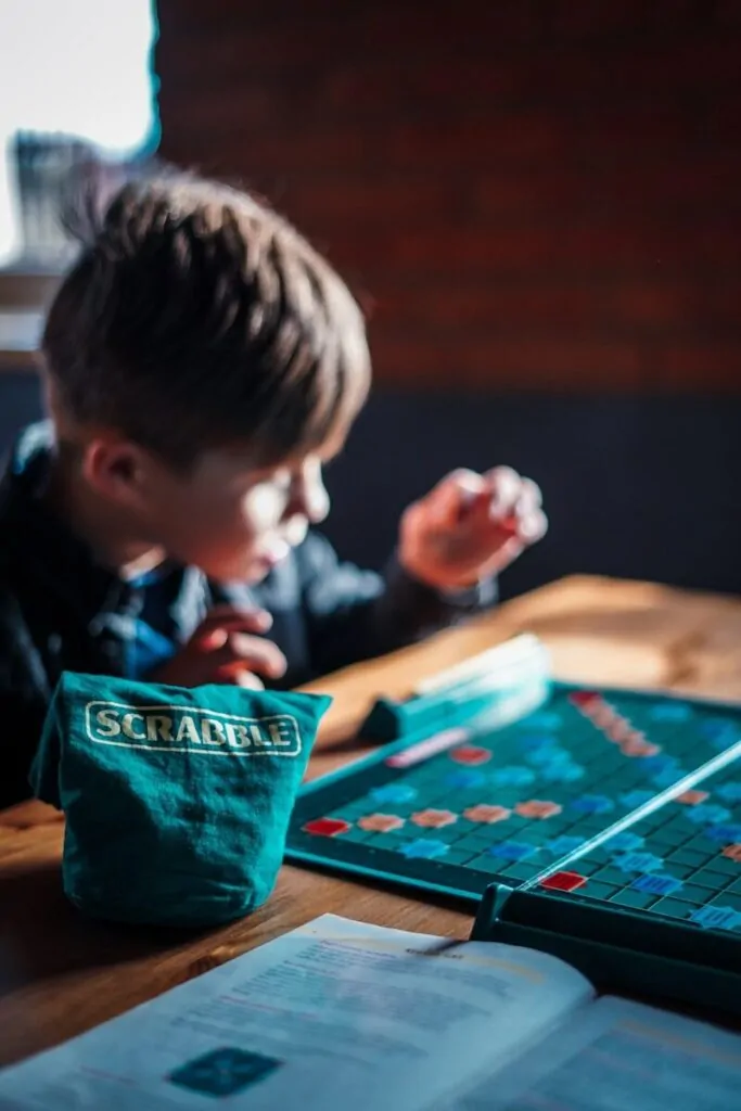 boy playing game on table