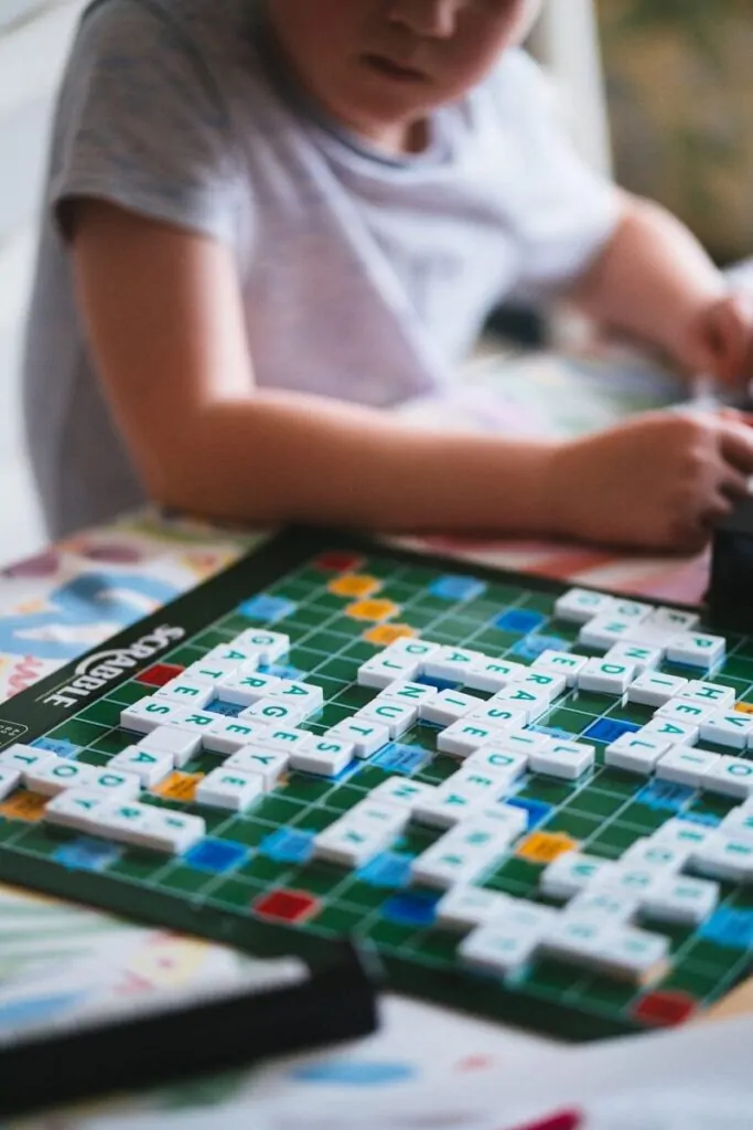A young boy playing a game of scrabble
