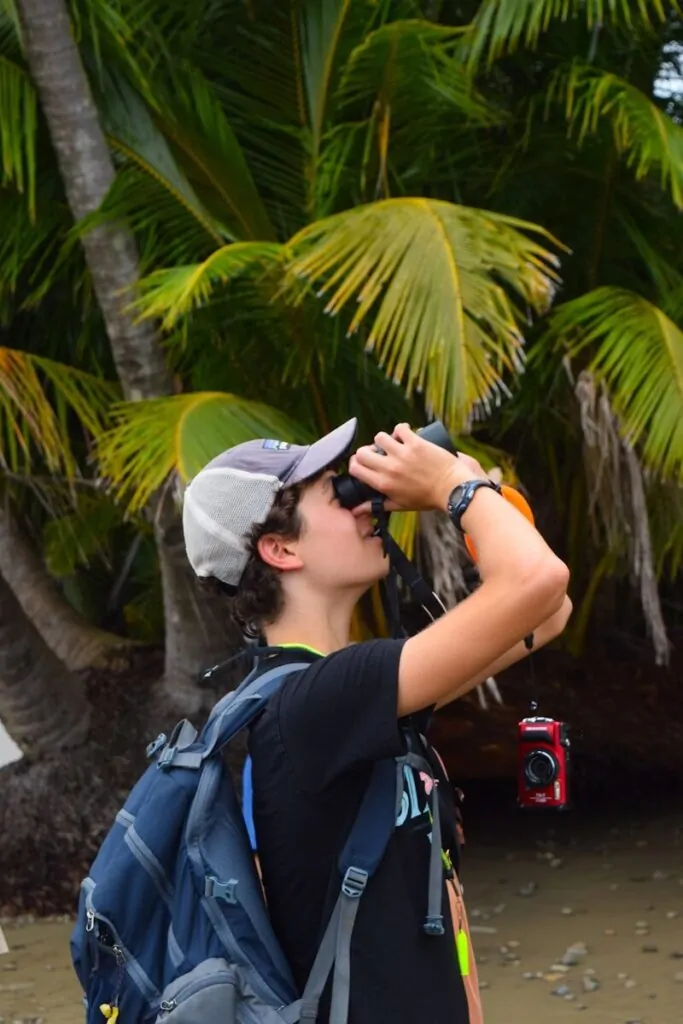 A person is looking through binoculars.