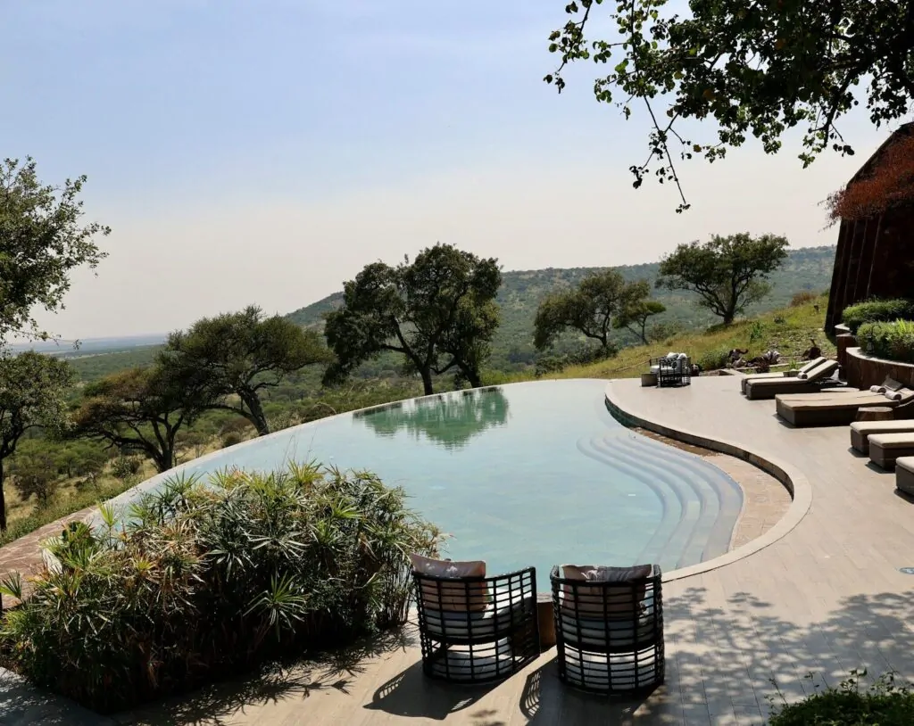 Design Your Dream Life With This Personality Quiz 1 a pool with a patio and chairs