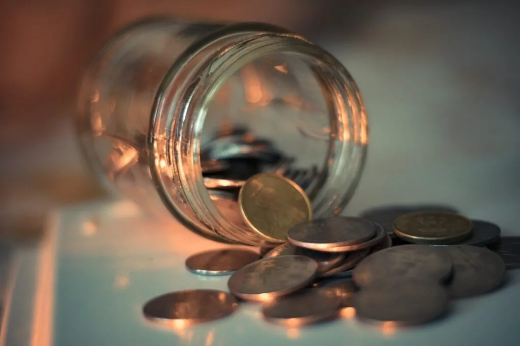 50 Good Habits That Can Improve Your Life Starting Today 8 clear glass jar with coins
