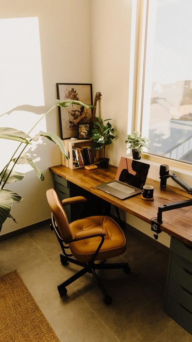 35+ Small Office Ideas for Working From Home 15 a desk with a laptop and a potted plant