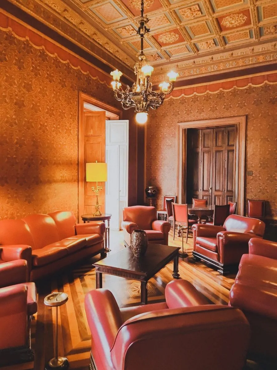 50 Luxury Living Room Ideas for Every Home Style 5 Luxurious vintage room featuring red leather armchairs and ornate chandelier.