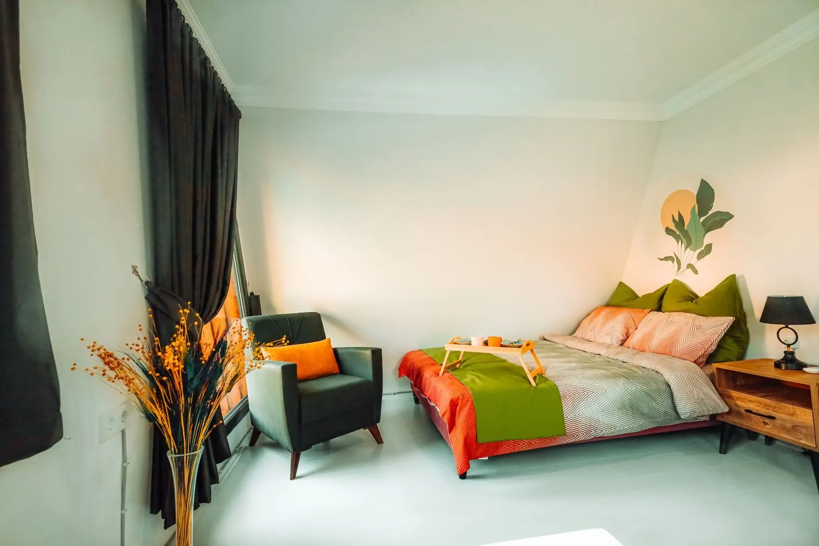35+ Room Decor Ideas for Small Spaces That Feel Bigger 35 A modern minimalist bedroom featuring colorful bedding, a stylish armchair, and a wooden bedside table.