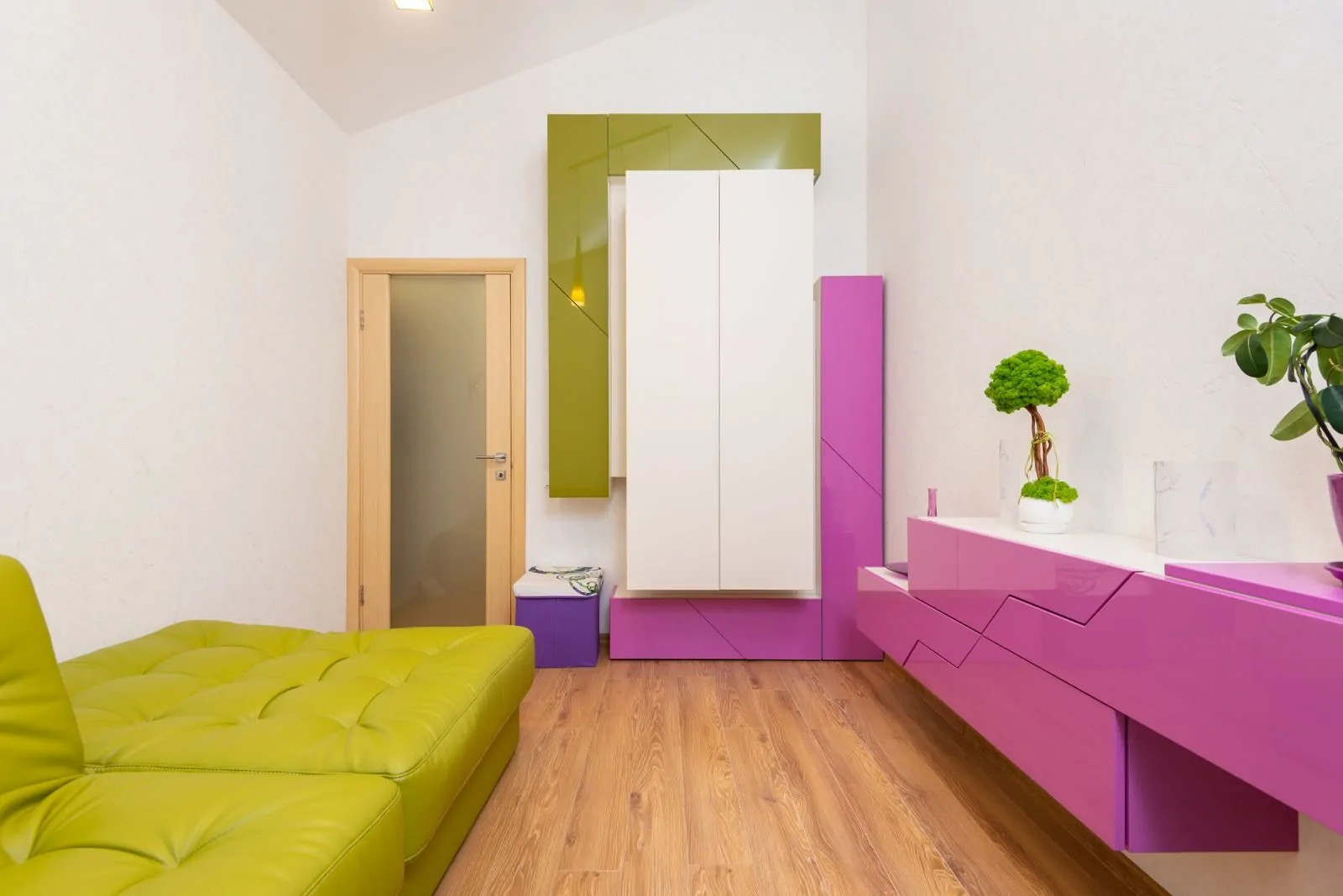 35+ Room Decor Ideas for Small Spaces That Feel Bigger 30 Interior of modern bedroom with comfortable green leather sofa and creative white and bright fuchsia colored furniture decorated with potted plants