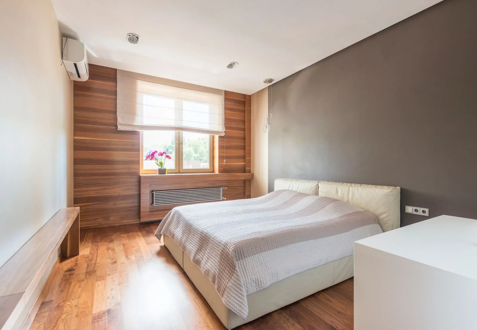 35+ Room Decor Ideas for Small Spaces That Feel Bigger 27 Bright and minimalist modern bedroom with wood accents and natural light through a window.