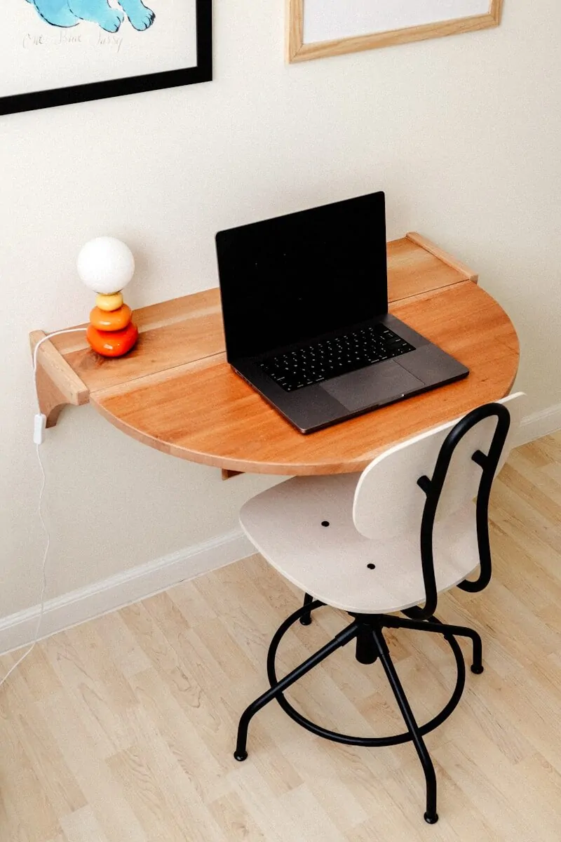 35+ Small Office Ideas for Working From Home 9 a laptop computer sitting on top of a wooden desk