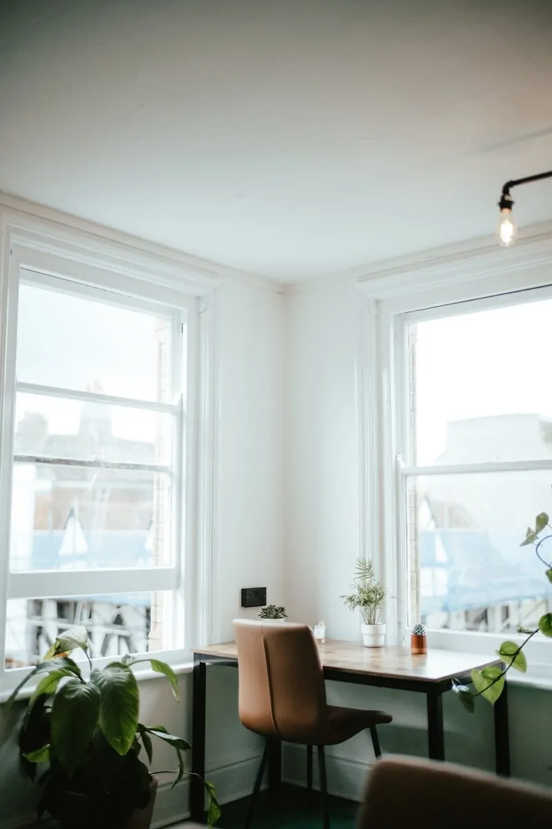 35+ Small Office Ideas for Working From Home 8 a room with a desk, chair and two windows