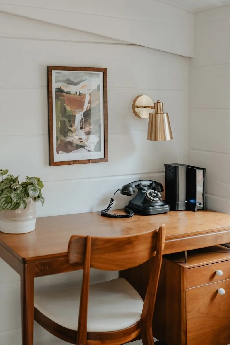 35+ Small Office Ideas for Working From Home 4 a wooden desk with a phone on top of it