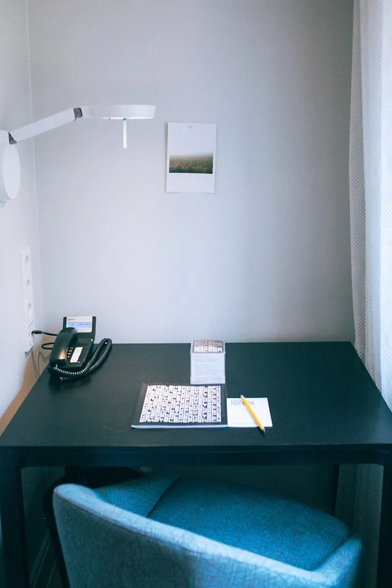 35+ Small Office Ideas for Working From Home 20 white and black book beside yellow pen and black telephone on rectangular black wooden table