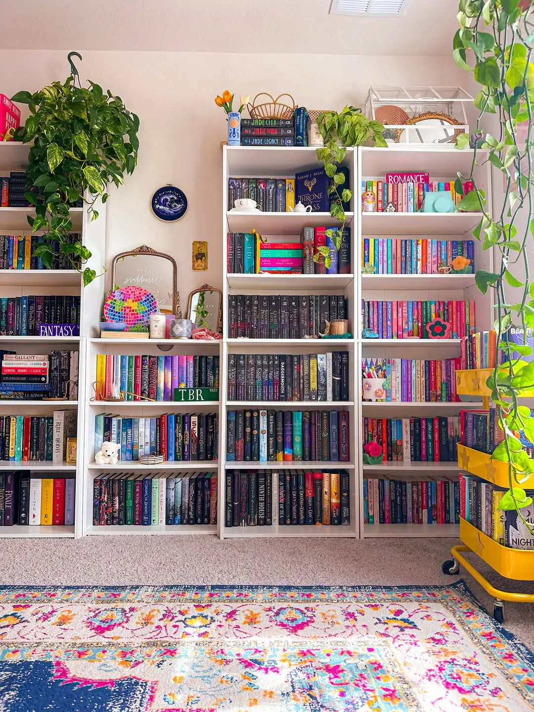 10 Home Library Ideas That Will Make You Want to Stay Home 1 Bright Shelves with Colorful Books and Plants