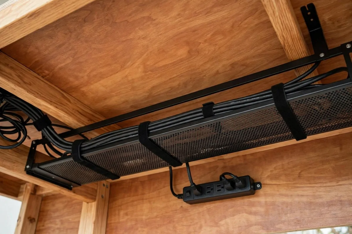 18 Podcast Room Setup Ideas for Crisp, Clear Sound 13 Tidy bundled cables under a podcast desk