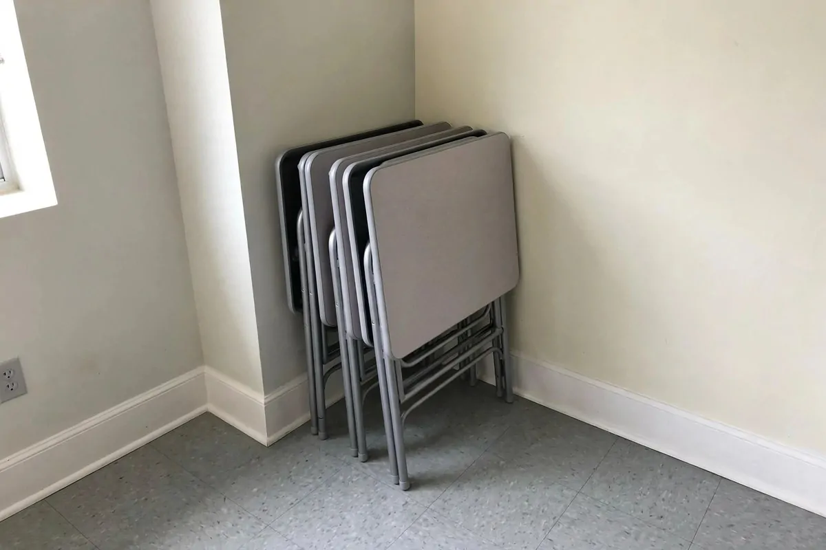 19 Small Classroom Setup Tricks for Maximum Space 5 Trapezoid student desks pushed together in a cluster with built-in book racks