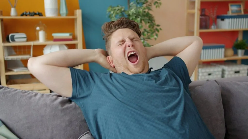 Am I Lazy Quiz: Answer 10 Funny Questions and Find Out Just How Lazy You Really Are 1 Man yawning widely with hands behind his head