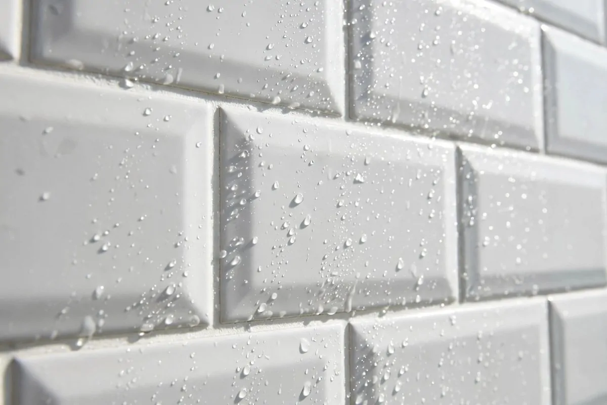 white bathroom tiles with bright clean grout lines close up
