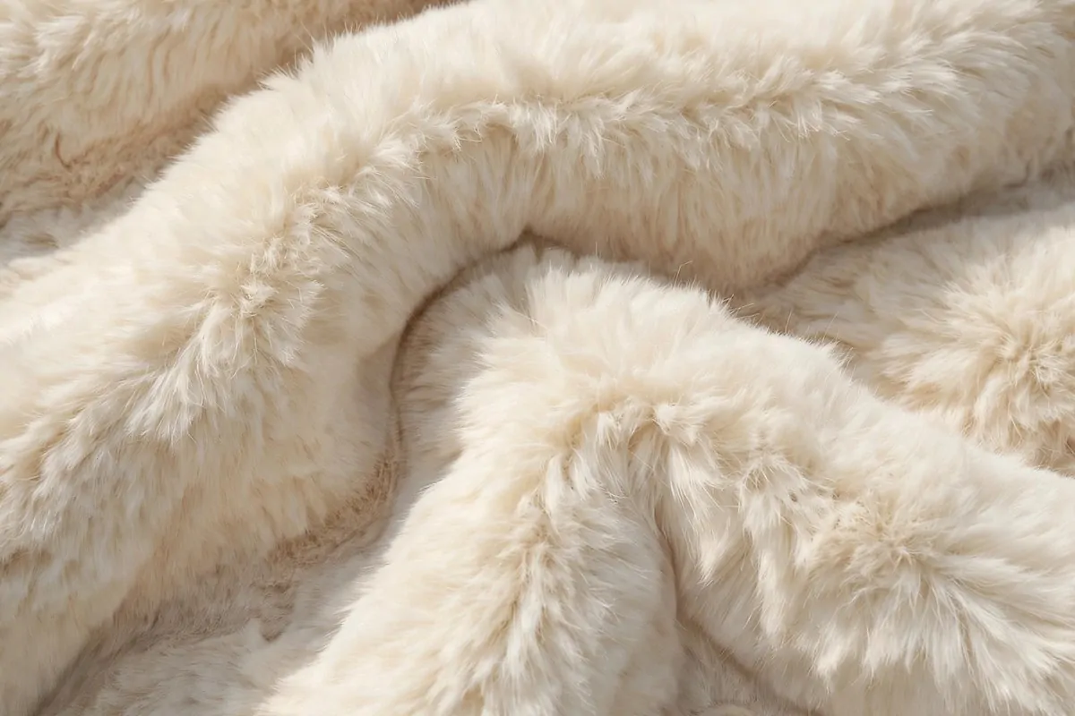Cream faux fur throw with plush texture as a studio backdrop