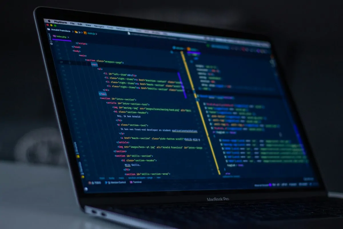 Am I Good at Coding Quiz: Take This Quick Test and See If You Have a Programmer's Brain 1 Laptop with code on screen