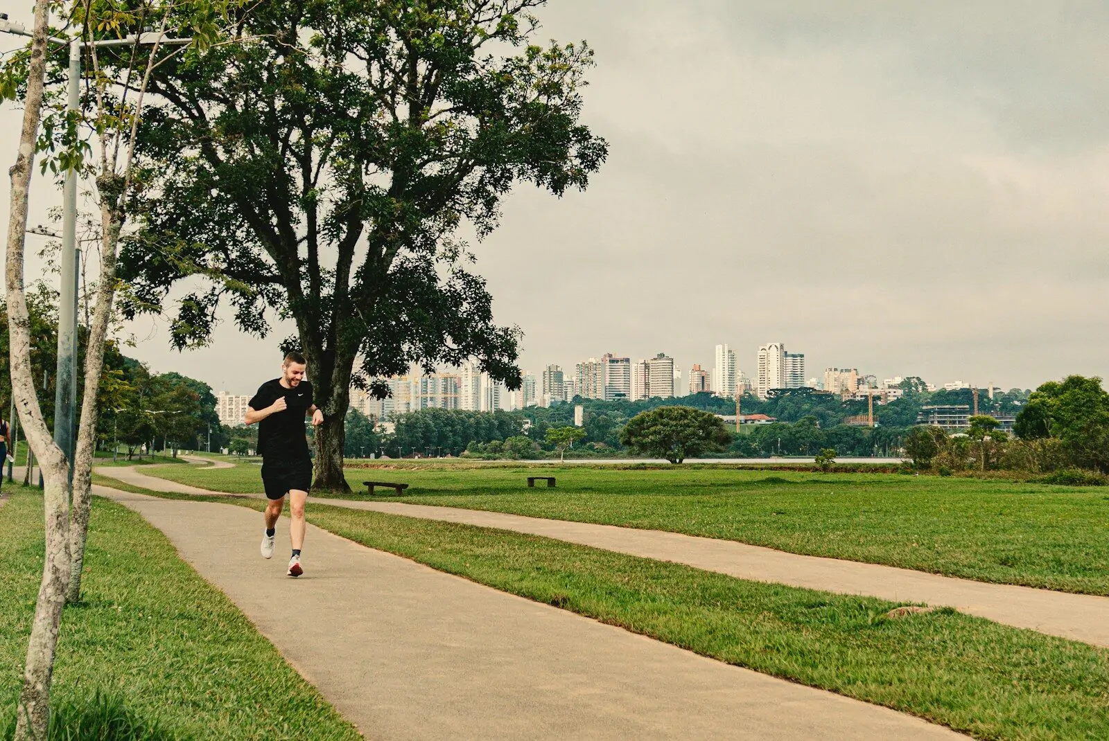 a man running down a path in a park