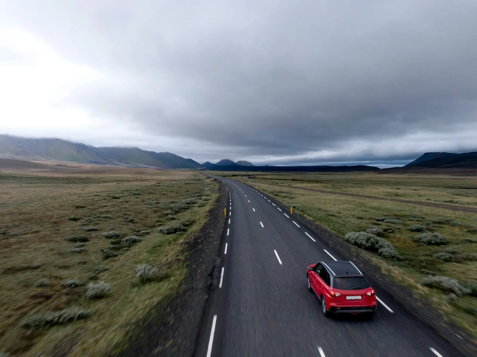 I Named 24 Car Brands in Under 2 Minutes - Take This Quiz and See If You Can Beat Me! 1 A red car driving on an asphalt road