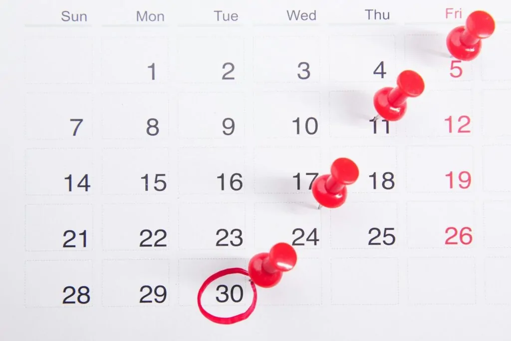 How to Organize My Life in 30 Days 1 a calendar with red push buttons pinned to it