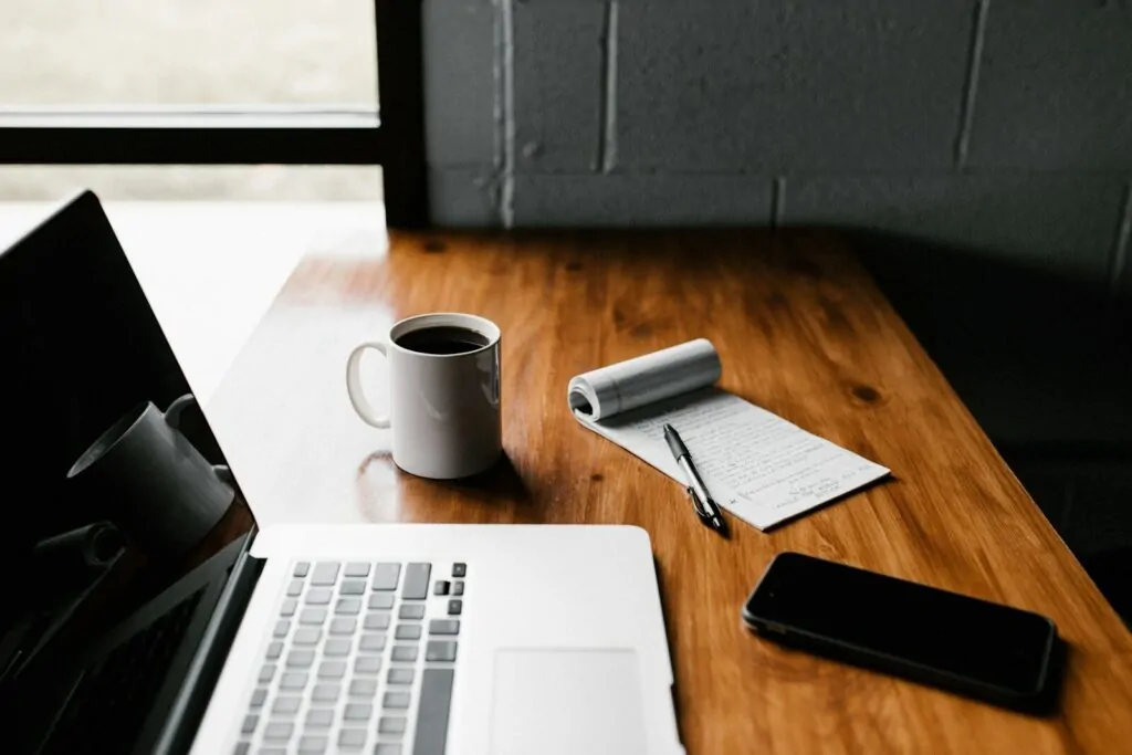 Am I Productive Quiz: Answer 10 Quick Questions and Find Out How Productive You Really Are 1 MacBook Pro, white ceramic mug,and black smartphone on table