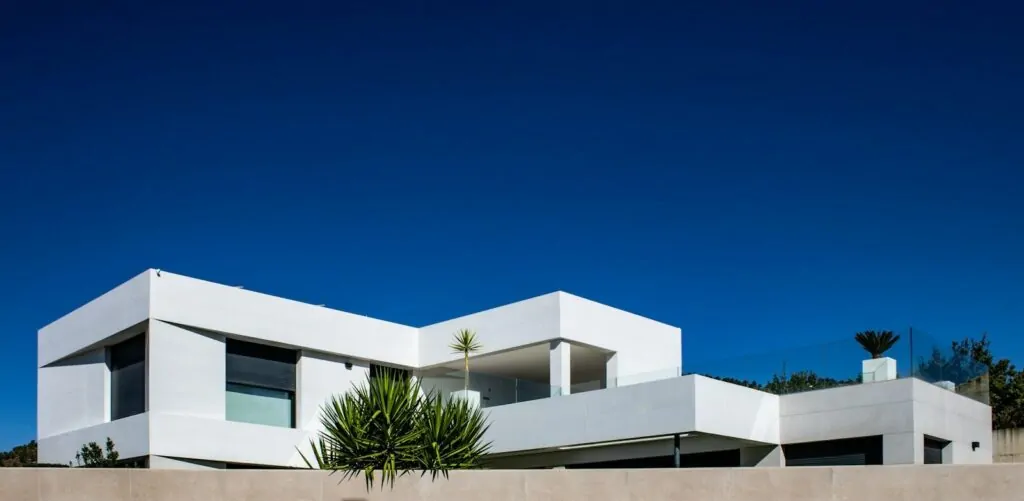Modern white house against a clear blue sky