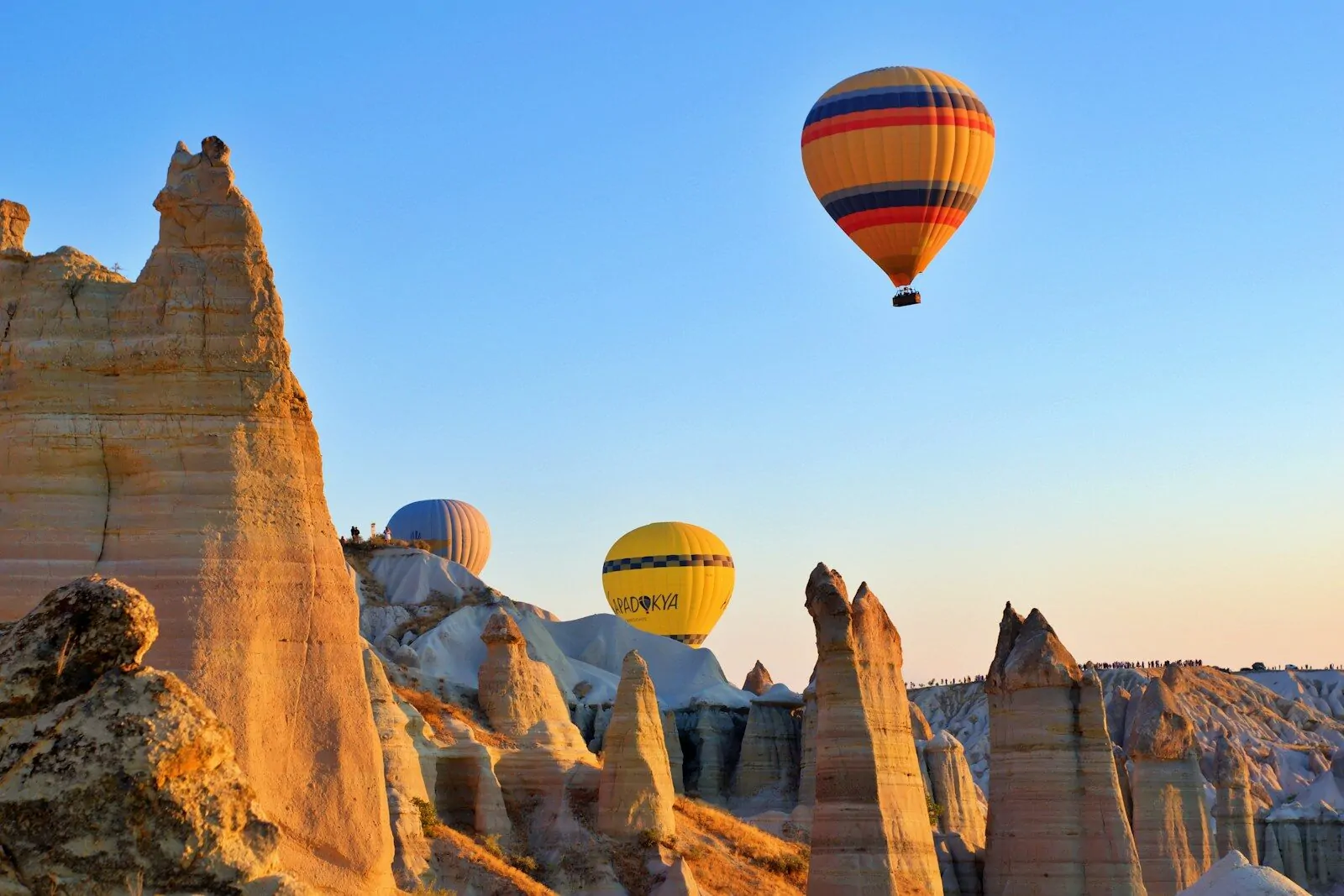 Countries From Their Famous Landmarks Quiz: Can You Name the Country Behind the Eiffel Tower, Taj Mahal, and Great Wall? 1 a group of hot air balloons flying over a rocky landscape