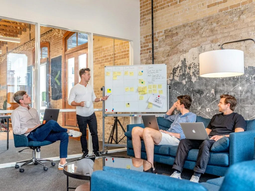 Am I a Good Leader Quiz: Answer 10 Questions and Find Out If You Have What It Takes to Lead 1 three men sitting while using laptops and watching man beside whiteboard