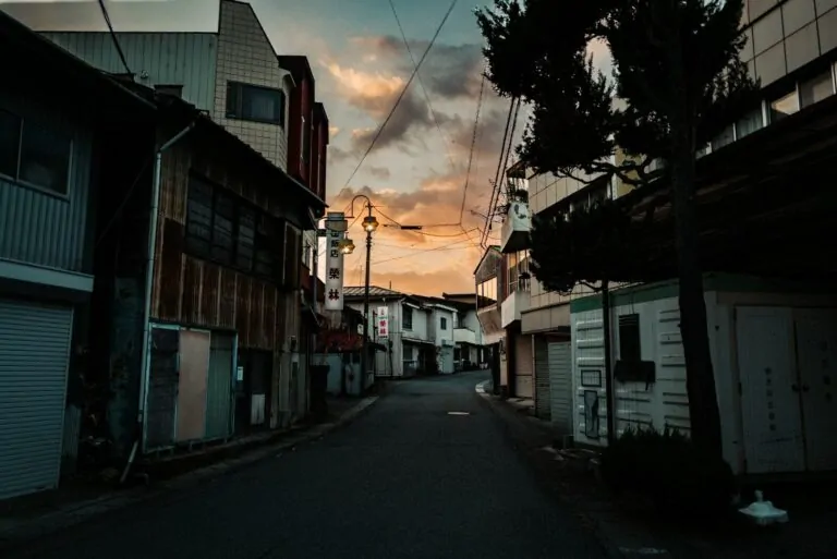 Street with buildings at sunset with dramatic clouds