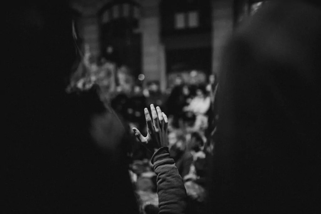 Am I a People Pleaser Quiz: Answer 10 Fun Questions and Find Out If You Say Yes Too Much 1 a black and white photo of a person's hand in the air
